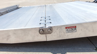 Close-up of the flat hinge on a tuckunder aluminum platform