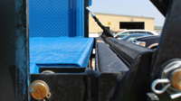 Close-up of the truck bed and platform of a Bi-Fold Railgate in the "drop down" position