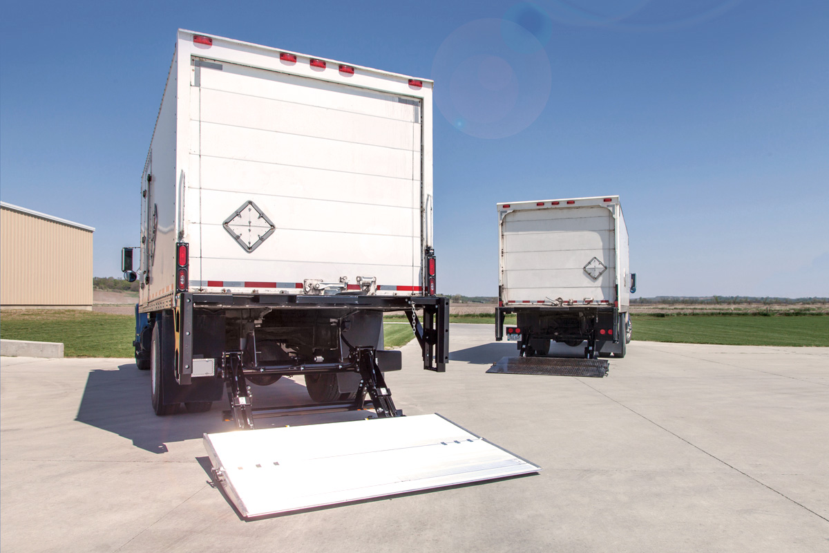 Two straight trucks with Tommy Gate Tuckunder Liftgates installed. 