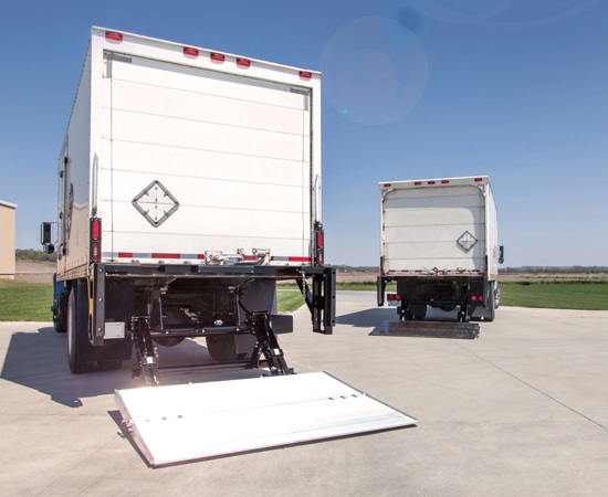 Two straight trucks with Tommy Gate Tuckunder Liftgates installed. 