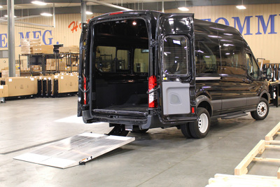 A 2015 Ford Transit commercial van with Tommy Gate Cantilever liftgate
