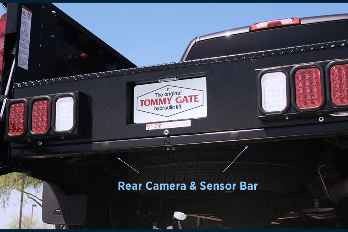A close up of a Tommy Gate Liftgate with Rear Camera & Sensor Bar